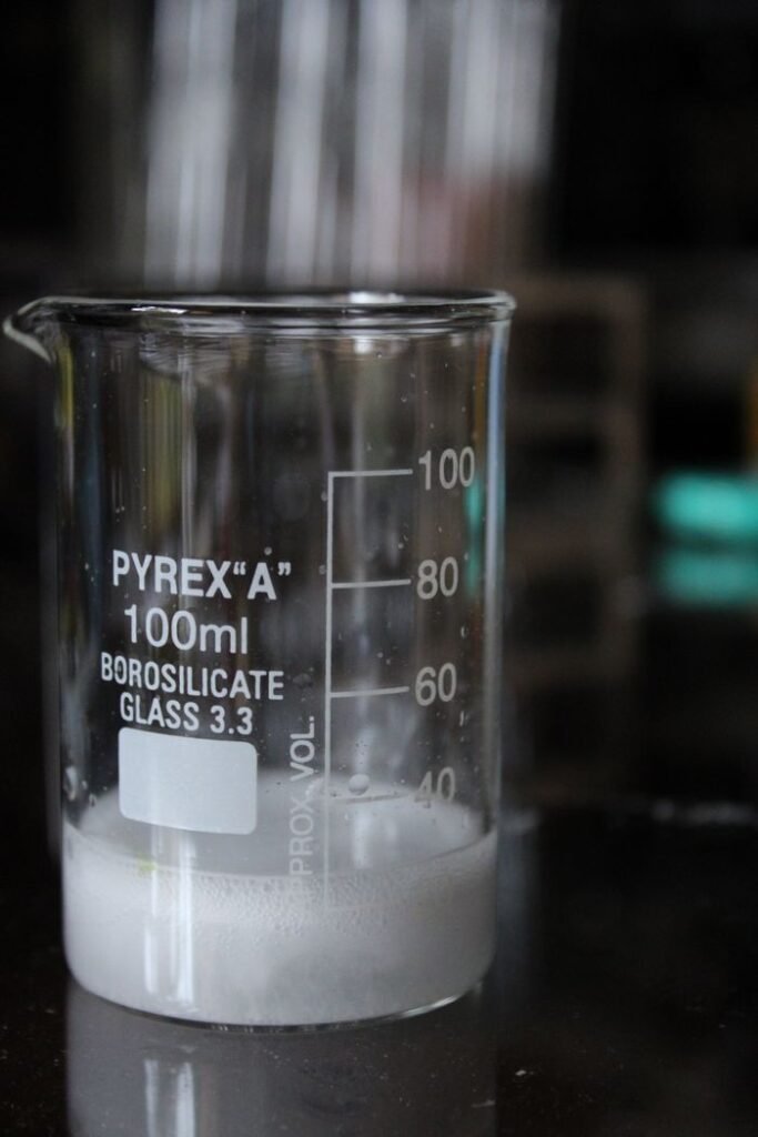 Palm Based Products & Cooking Oils Close-up of a Pyrex beaker with white residue, ideal for science stock use.