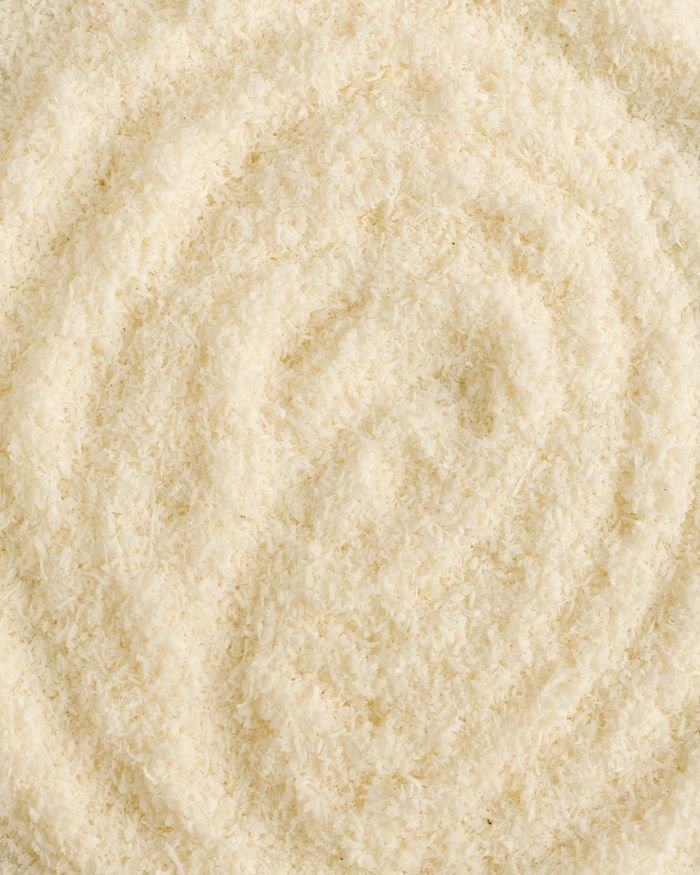 Detailed view of textured beige wool fabric forming a spiral pattern, ideal for textile and fashion backgrounds.